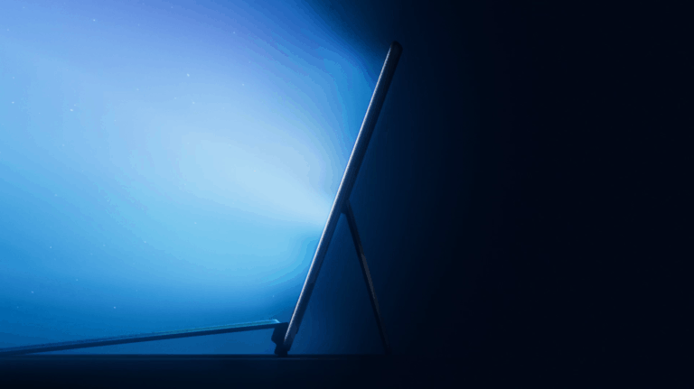 Microsoft Surface Event image featuring a laptop, with a glowing screen and particle effects