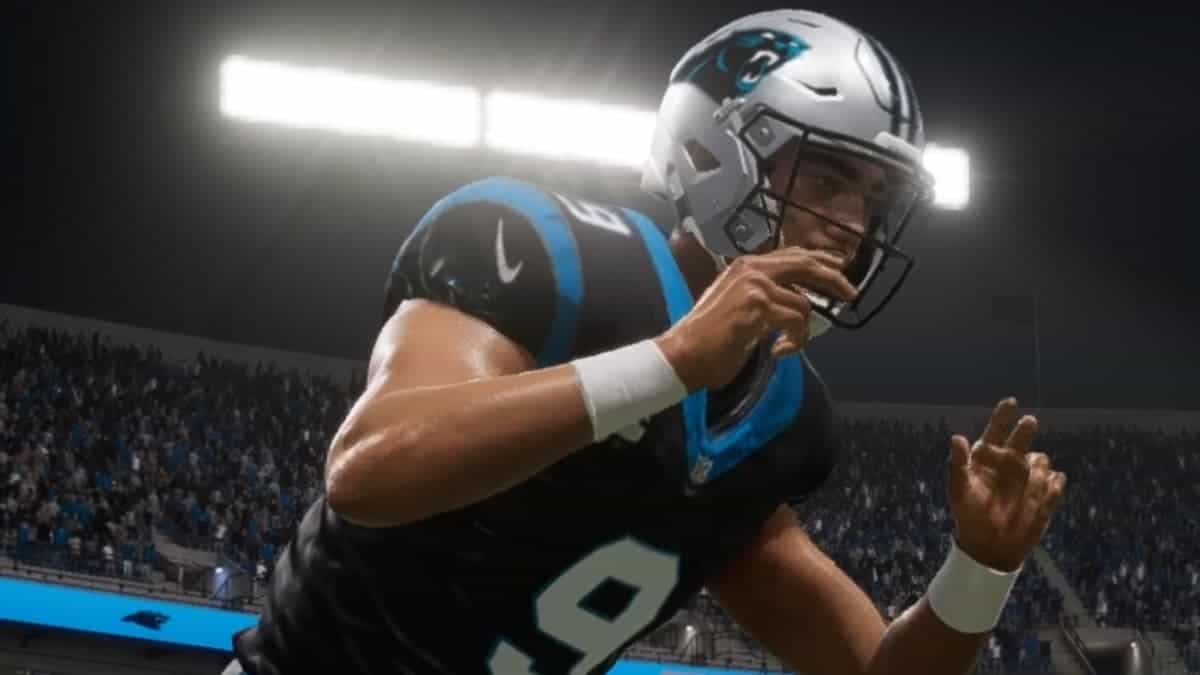 The Carolina Panthers football player is throwing a ball during a review.