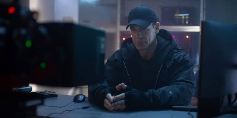 overwatch 2 john cena live action sits in secret room with black clothes behind computers