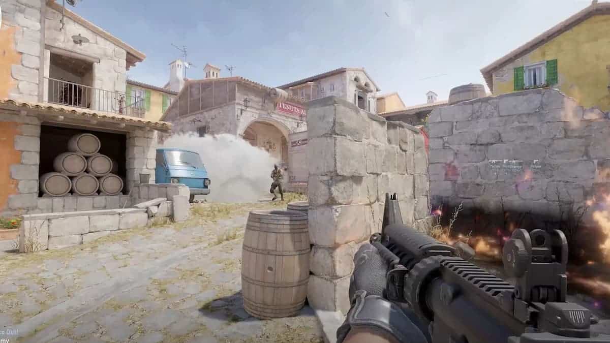 cs2 first person shooter view firing gun at enemy behind stone wall barrels in stone town at daytime