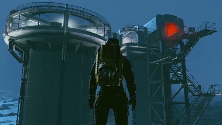 starfield astronaut stands in front of large base with towers stairs and red light at nighttime