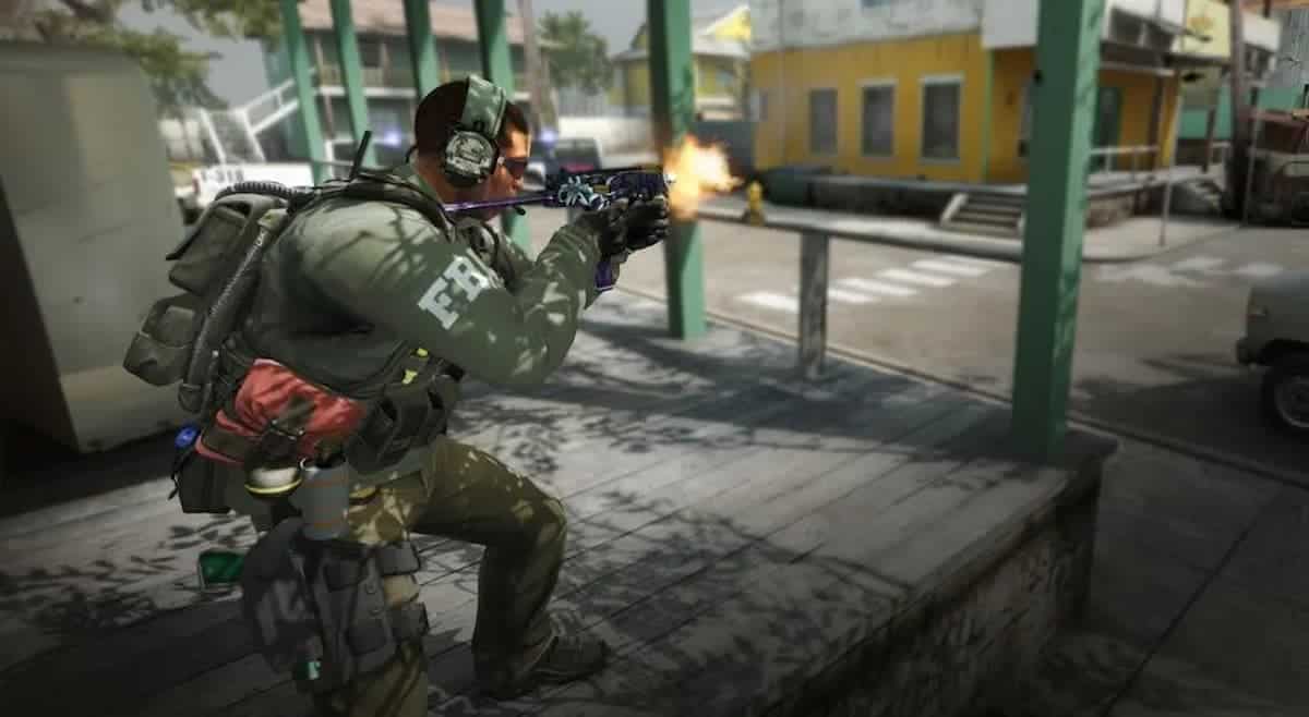 cs2 soldier in green gear stands and fires smg weapon towards street on platform during daytime